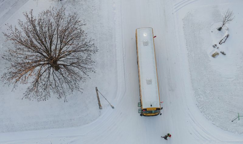 Students board a school bus on Wednesday in Wichita, Kan.