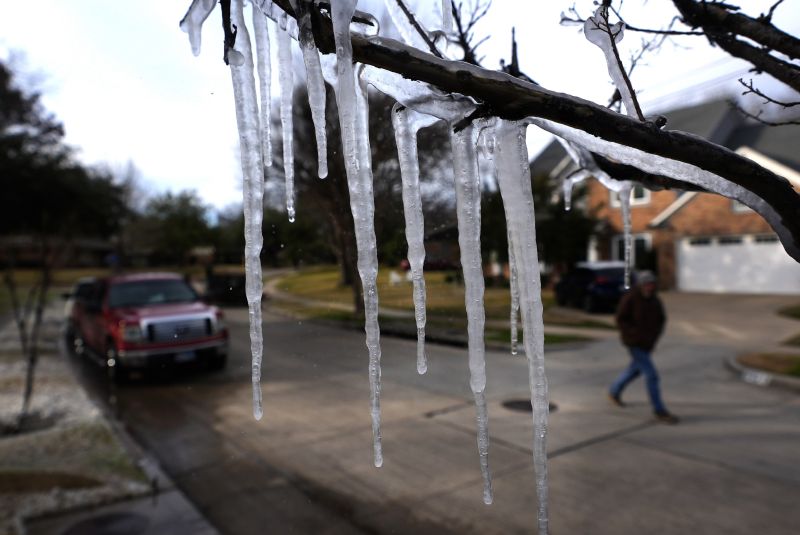 Cold temperatures and a lawn sprinkler create icicle on a tree ahead of a winter storm expected to hit the North Texas region, seen Wednesday, in Richardson, Texas.