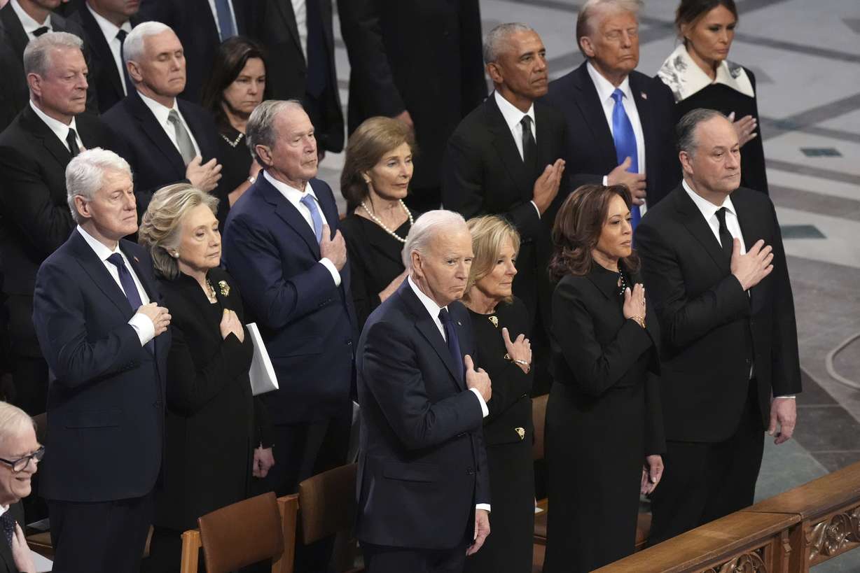 President Joe Biden, first lady Jill Biden, Vice President Kamala Harris and second gentleman Doug Emhoff, former President Bill Clinton, former Secretary of State Hillary Clinton, former President George W. Bush, Laura Bush, former President Barack Obama, President-elect Donald Trump and Melania Trump, stand during the state funeral for former President Jimmy Carter at Washington National Cathedral in Washington, Thursday.