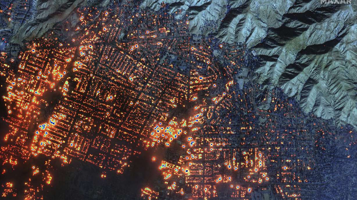 This satellite image provided by Maxar Technologies shows the Eaton Fire on Wednesday in Altadena, Calif. Firefighters are making progress Thursday slowing wildfires in the area.