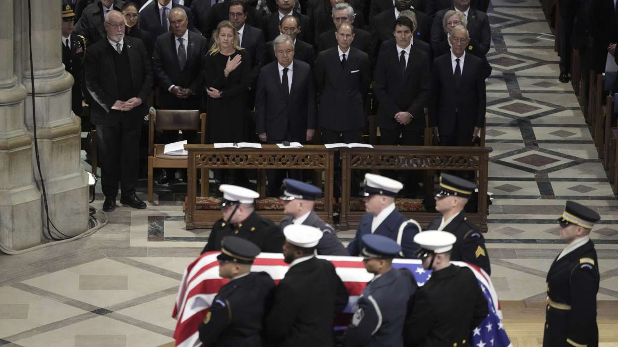 The flag-draped casket of former President Jimmy Carter departs after a state funeral at Washington National Cathedral in Washington, Thursday.