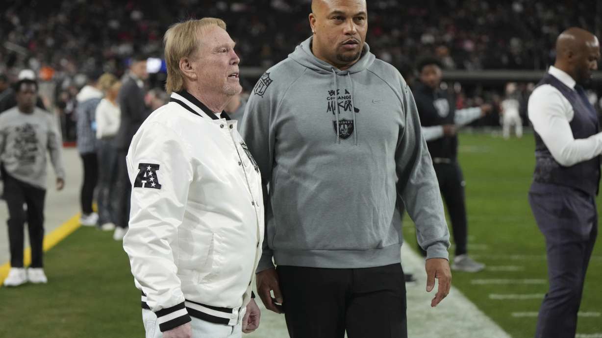 Las Vegas Raiders owner Mark Davis talks with head coach Antonio Pierce, right, prior to an NFL football game against the Atlanta Falcons, Monday, Dec. 16, 2024, in Las Vegas.
