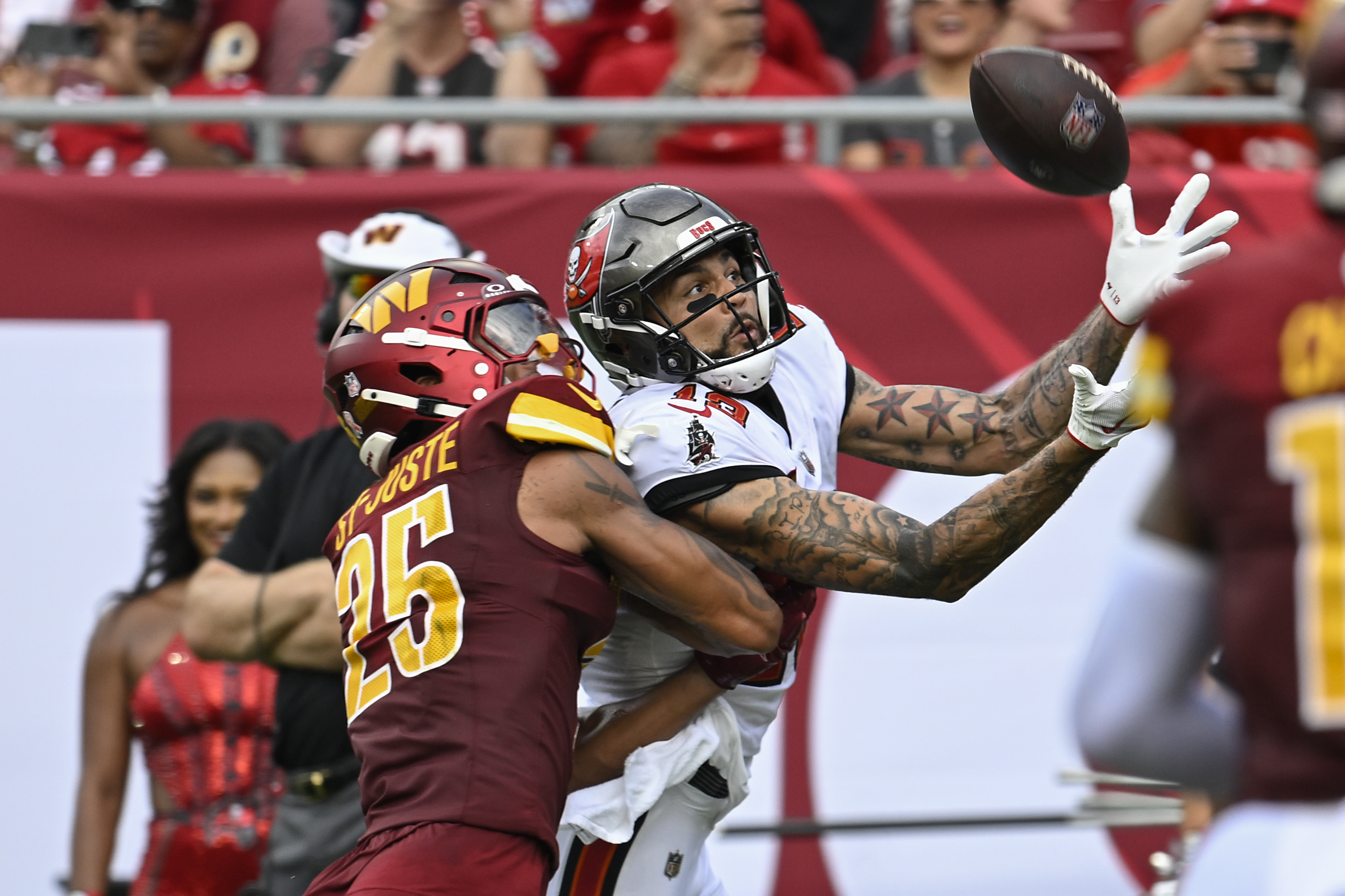 FILE - Tampa Bay Buccaneers wide receiver Mike Evans, right, makes a reception for a touchdown in front of Washington Commanders cornerback Benjamin St-Juste (25) during the first half of an NFL football game, Sept. 8, 2024, in Tampa, Fla.