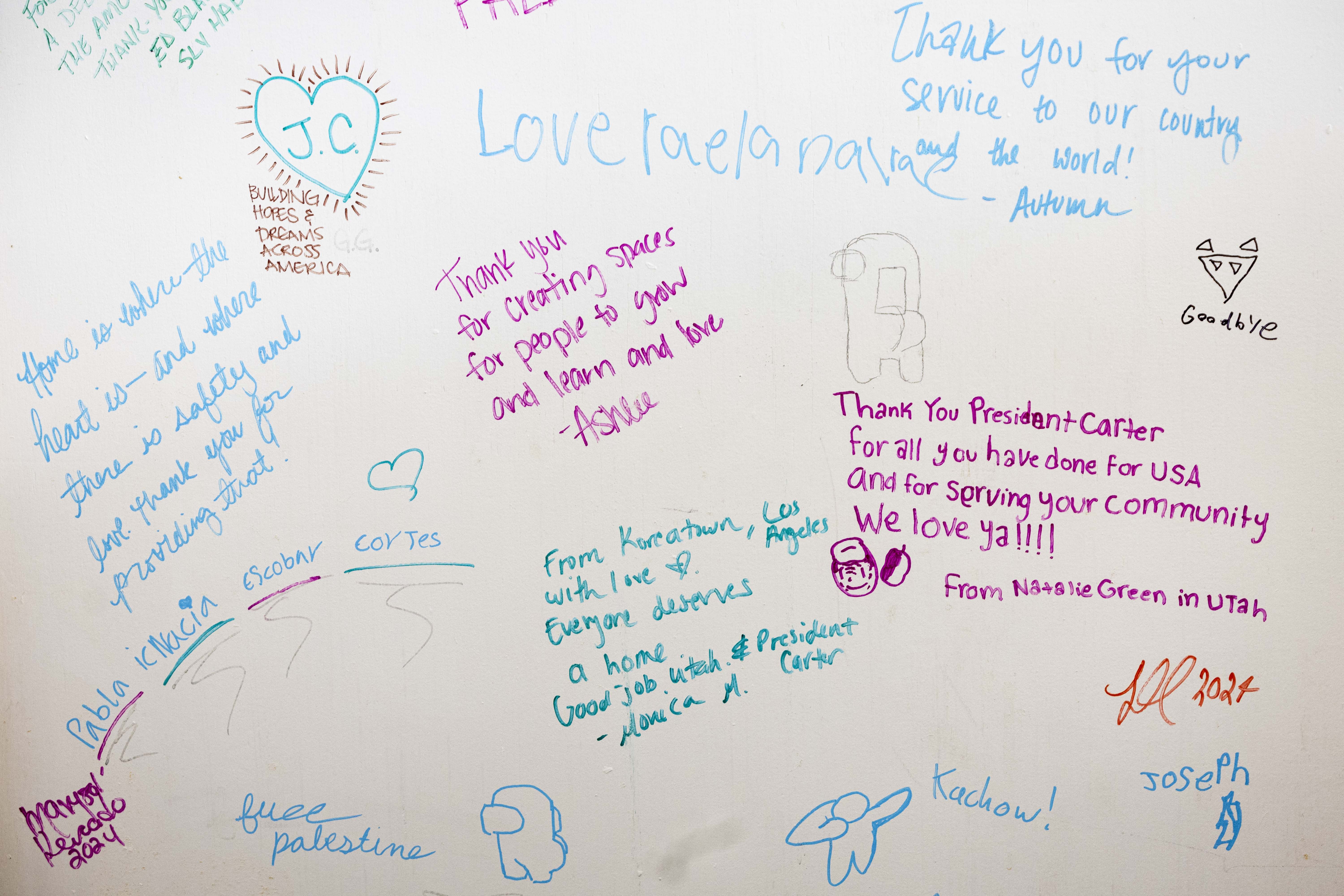 Messages and signatures are displayed on a door to a memorial wall for the late President Jimmy Carter at the Habitat for Humanity Salt Lake ReStore in Salt Lake City on Thursday.