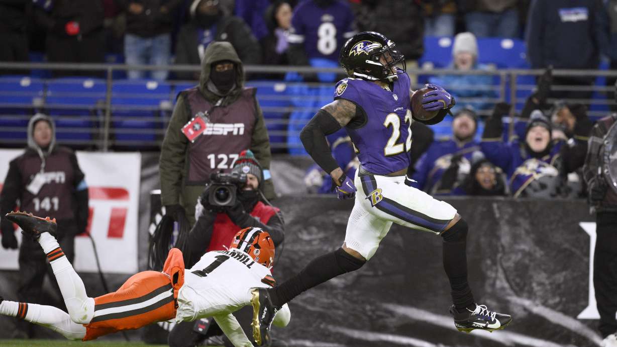 Baltimore Ravens running back Derrick Henry, right, scores past Cleveland Browns safety Juan Thornhill (1) on a 43-yard touchdown run during the second half of an NFL football game Saturday, Jan. 4, 2025, in Baltimore.