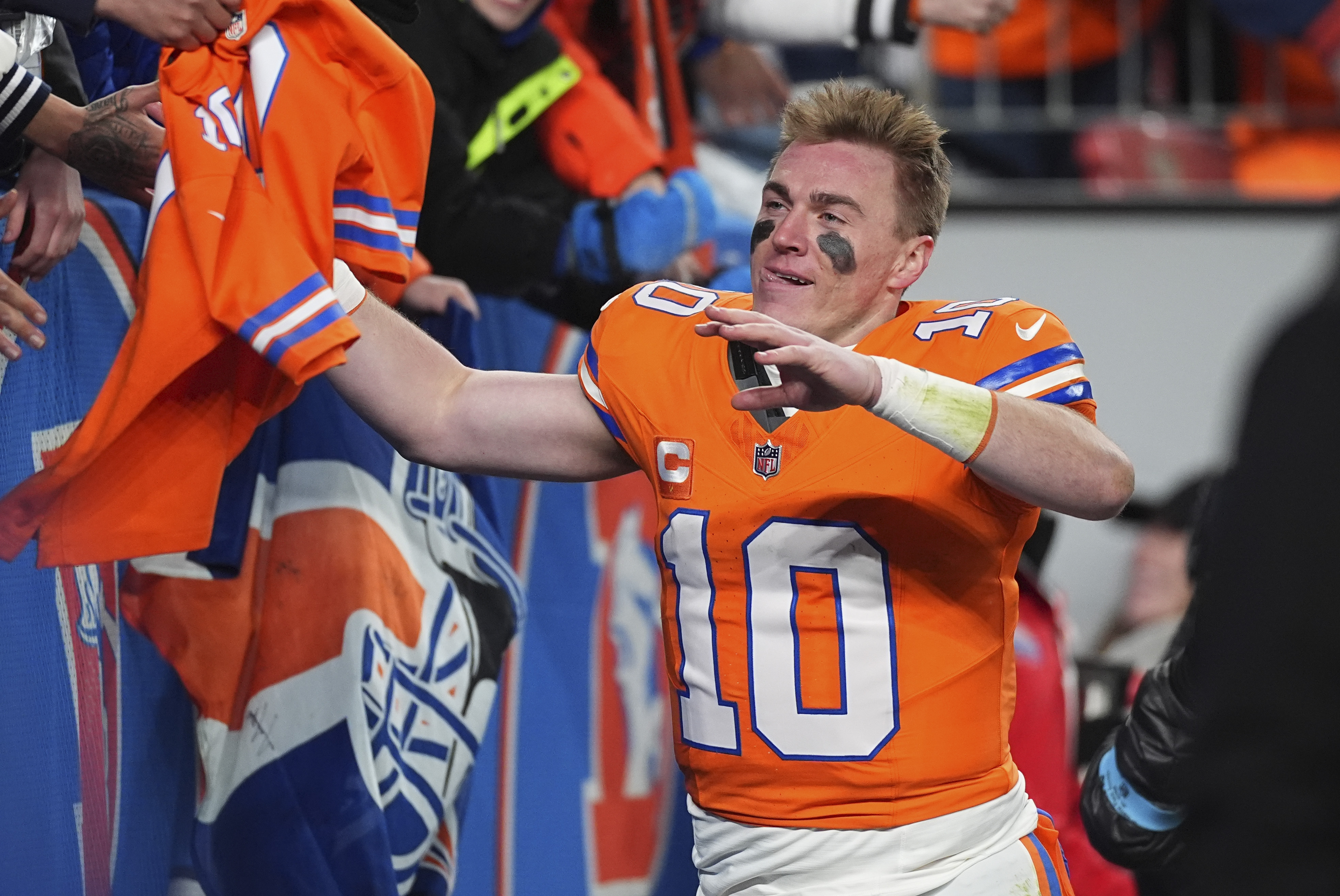 Fans congratulate Denver Broncos quarterback Bo Nix after an NFL football game against the Kansas City Chiefs, Sunday, Jan. 5, 2025, in Denver.