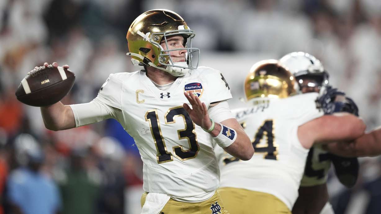 Notre Dame quarterback Riley Leonard (13) aims a pass during first half of the Orange Bowl NCAA College Football Playoff semifinal game against Penn State, Thursday, Jan. 9, 2025, in Miami Gardens, Fla.