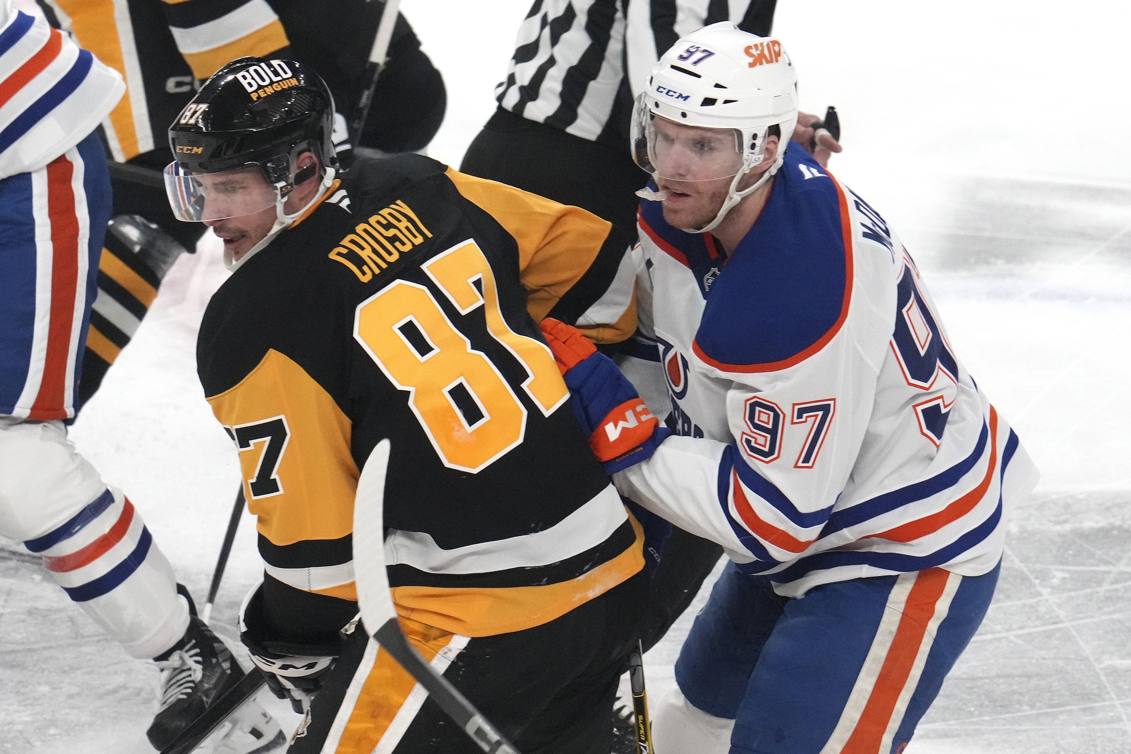 Pittsburgh Penguins' Sidney Crosby (87) and Edmonton Oilers' Connor McDavid (97) compete during the first period of an NHL hockey game in Pittsburgh, Thursday, Jan. 9, 2025. 