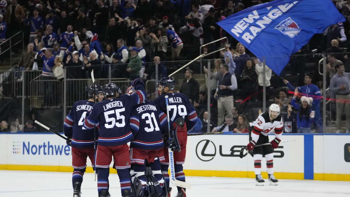 New York Rangers goaltender Igor Shesterkin (31) celebrates with teammates Ryan Lindgren (55), K'Andre Miller (79) and Braden Schneider (4) as New Jersey Devils' Brett Pesce (22) leaves the ice after an NHL hockey game, Thursday, Jan. 9, 2025, in New York.