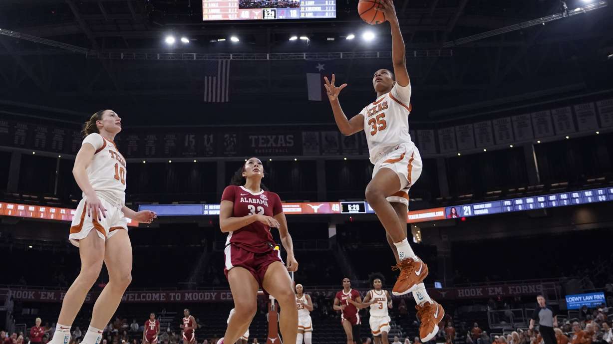 Texas forward Madison Booker (35) drives to the basket past Alabama guard Aaliyah Nye (32) during the second half of an NCAA college basketball game in Austin, Texas, Thursday, Jan. 9, 2025.