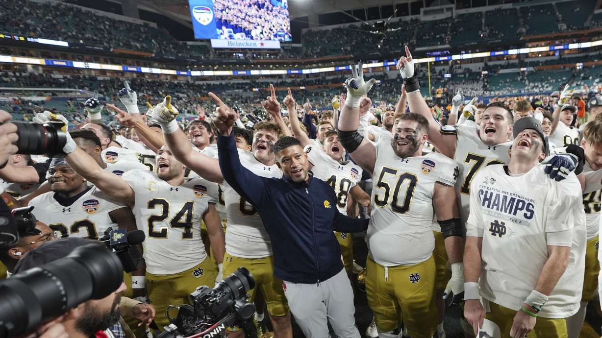 Notre Dame head coach Marcus Freeman an the team sing to fans after winning the Orange Bowl College Football Playoff semifinal game against Penn State, Thursday, Jan. 9, 2025, in Miami Gardens, Fla.
