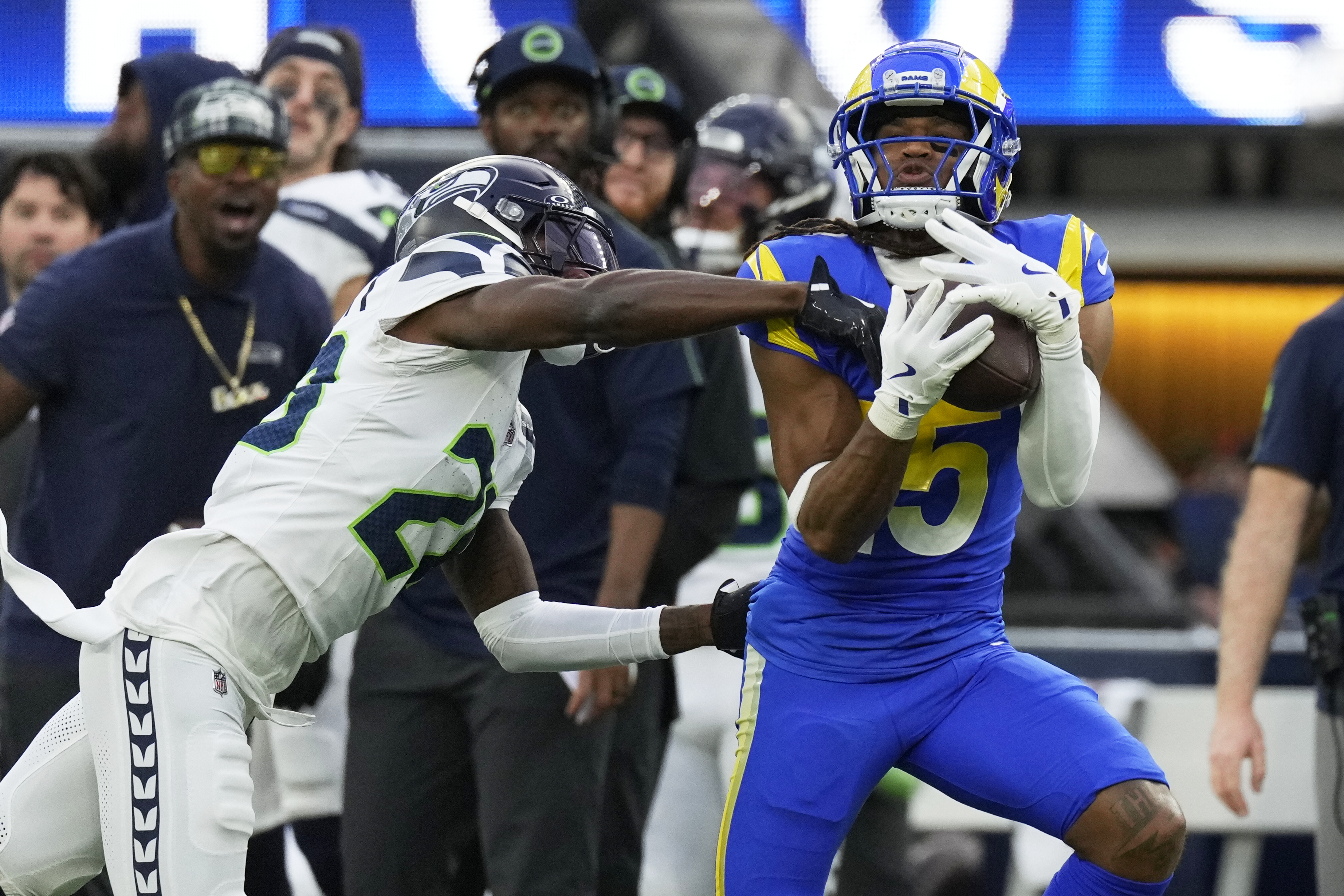 Los Angeles Rams wide receiver Demarcus Robinson (15) makes a catch past Seattle Seahawks cornerback Nehemiah Pritchett (28) during the first half of an NFL football game Sunday, Jan. 5, 2025, in Inglewood, Calif.