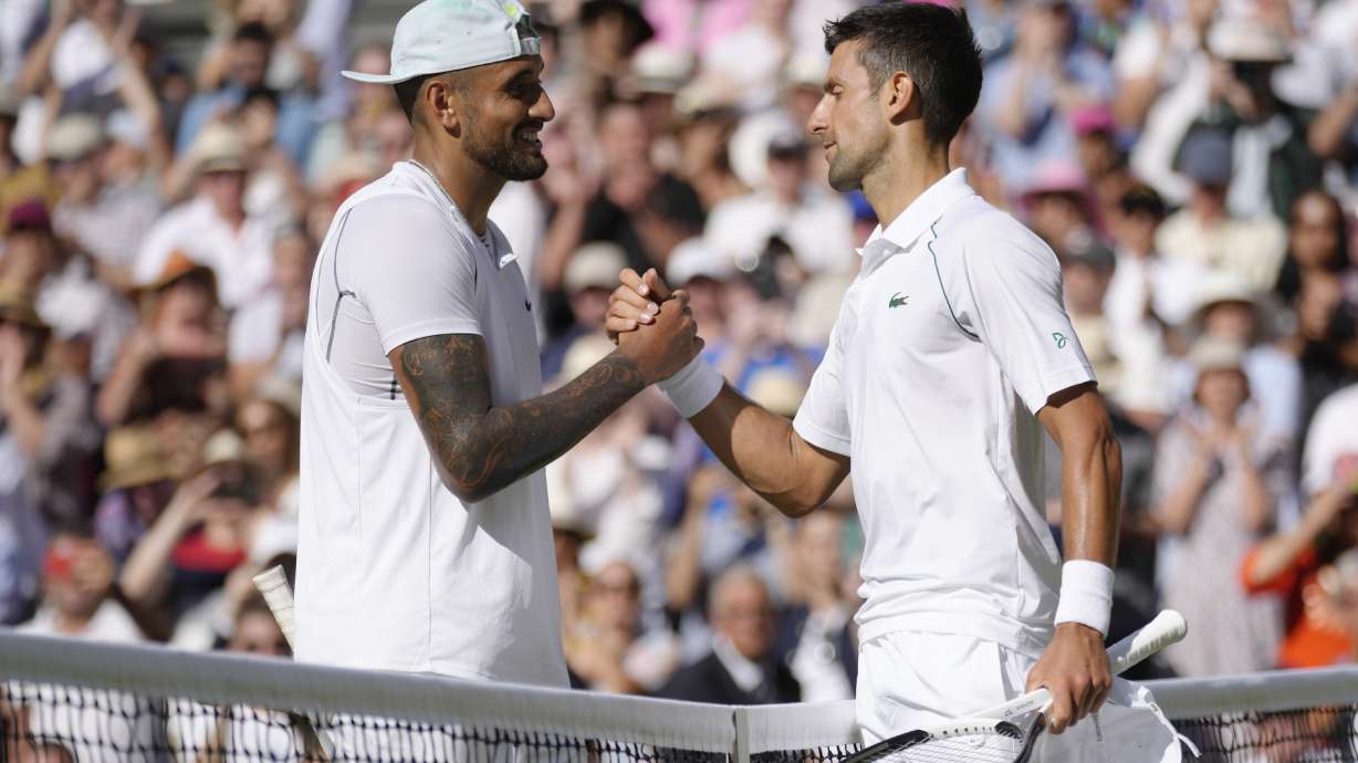 FILE - Serbia's Novak Djokovic, right, celebrates beating Australia's Nick Kyrgios in the final of the men's singles on day fourteen of the Wimbledon tennis championships in London, Sunday, July 10, 2022.