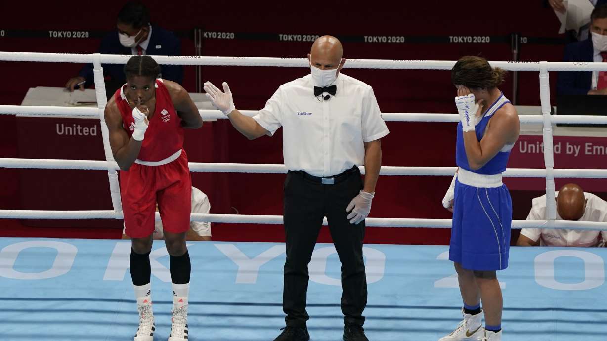 FILE -Caroline Dubois, of Great Britain, left, reacts after defeating Donjeta Sadiku, of Kosovo, right, in a light weight (60kg) preliminary boxing match at the 2020 Summer Olympics, July 27, 2021, in Tokyo, Japan.