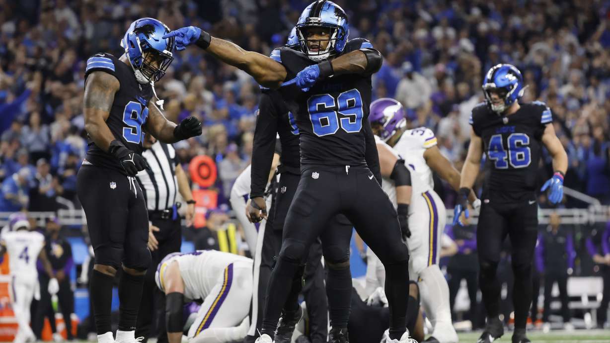Detroit Lions linebacker Al-Quadin Muhammad (69) celebrates after helping to sack Minnesota Vikings quarterback Sam Darnold during the second half of an NFL football game Sunday, Jan. 5, 2025, in Detroit.