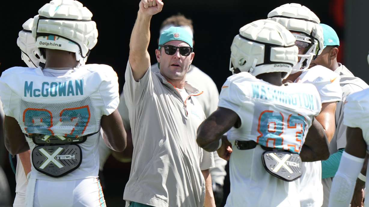 FILE - Miami Dolphins wide receivers coach Wes Welker, center, talks with players during practice at the NFL football team's training facility, Tuesday, Aug. 13, 2024, in Miami Gardens, Fla.