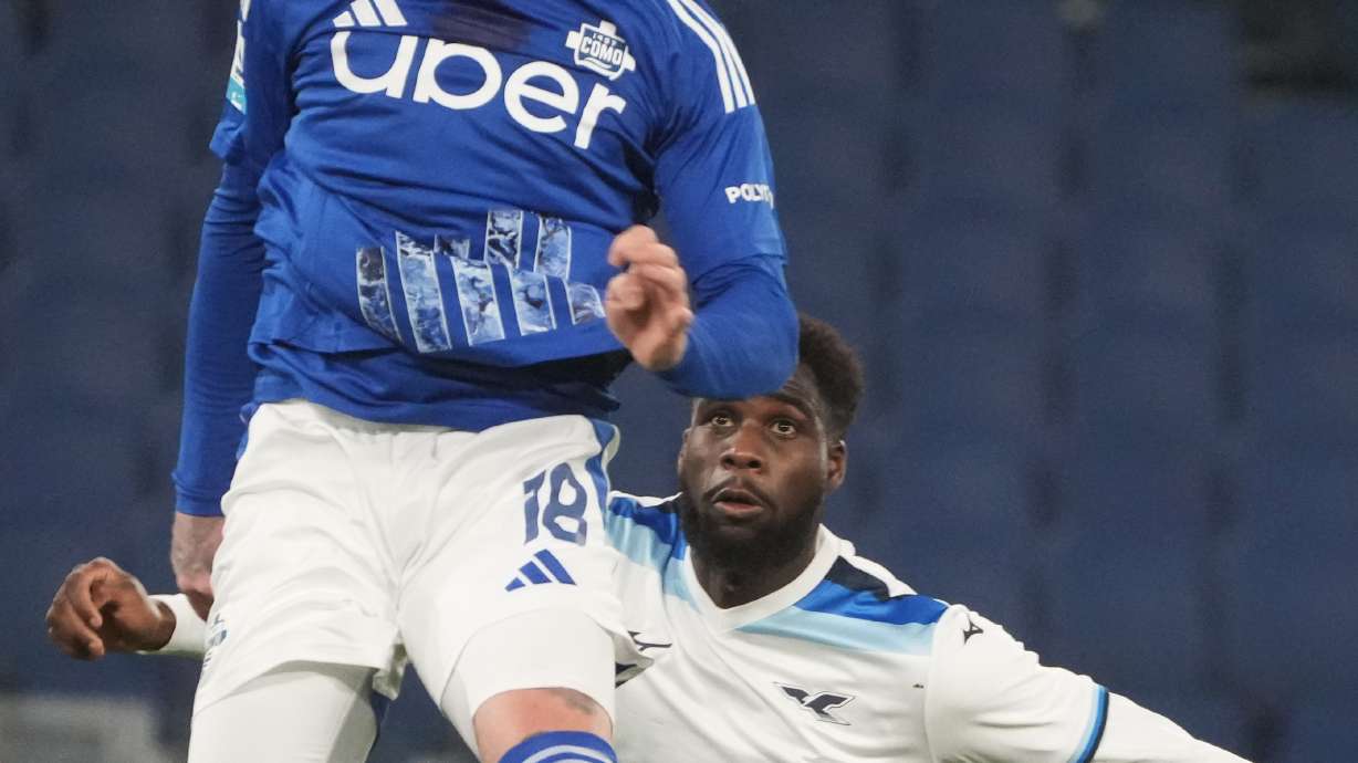 Como's Alberto Moreno, top, and Lazio's Boulaye Dia challenge for the ball during the Italian Serie A soccer match between Lazio and Como at Rome's Olympic stadium, Friday, Jan. 10, 2025.