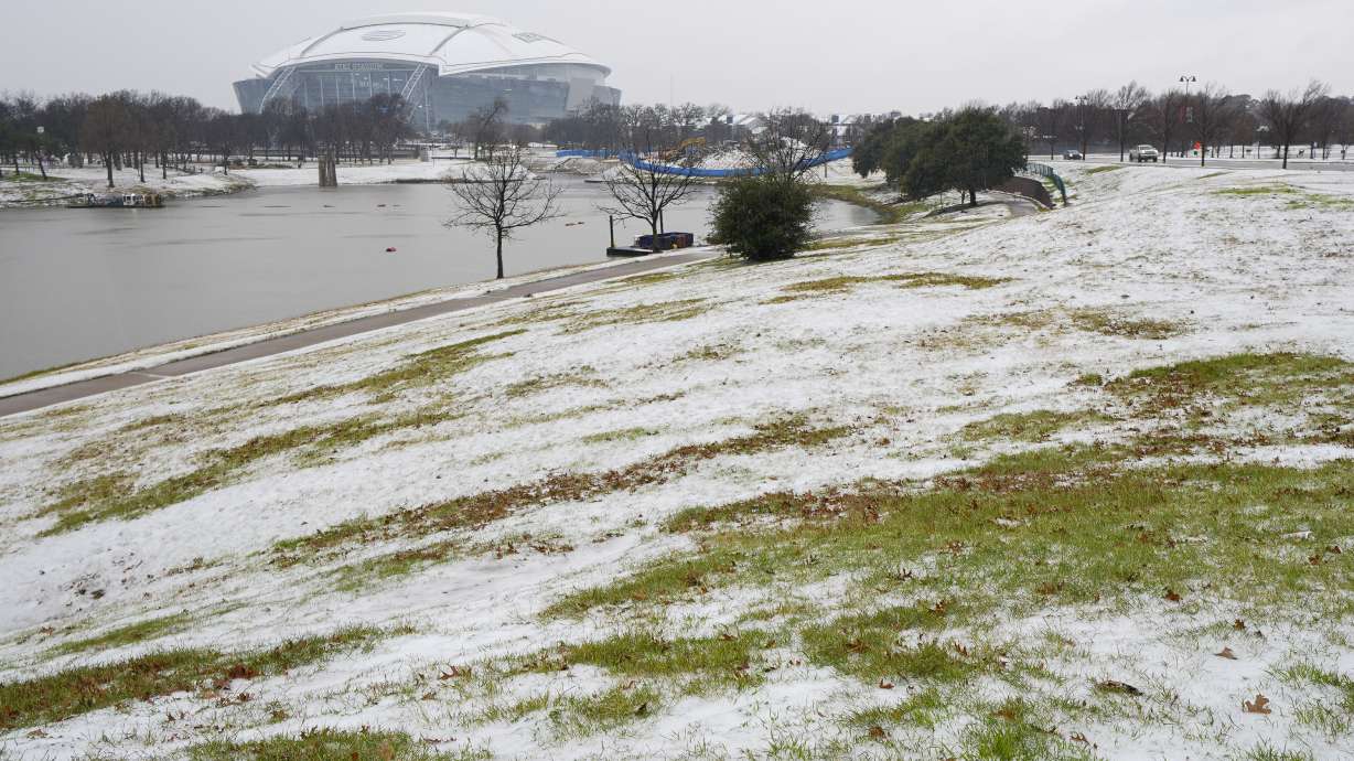 Snow is accumulated near AT&T Stadium a day prior to the Cotton Bowl NCAA College Football Playoff semifinal game between Ohio State and Texas, Thursday, Jan. 9, 2025, in Arlington, Texas.