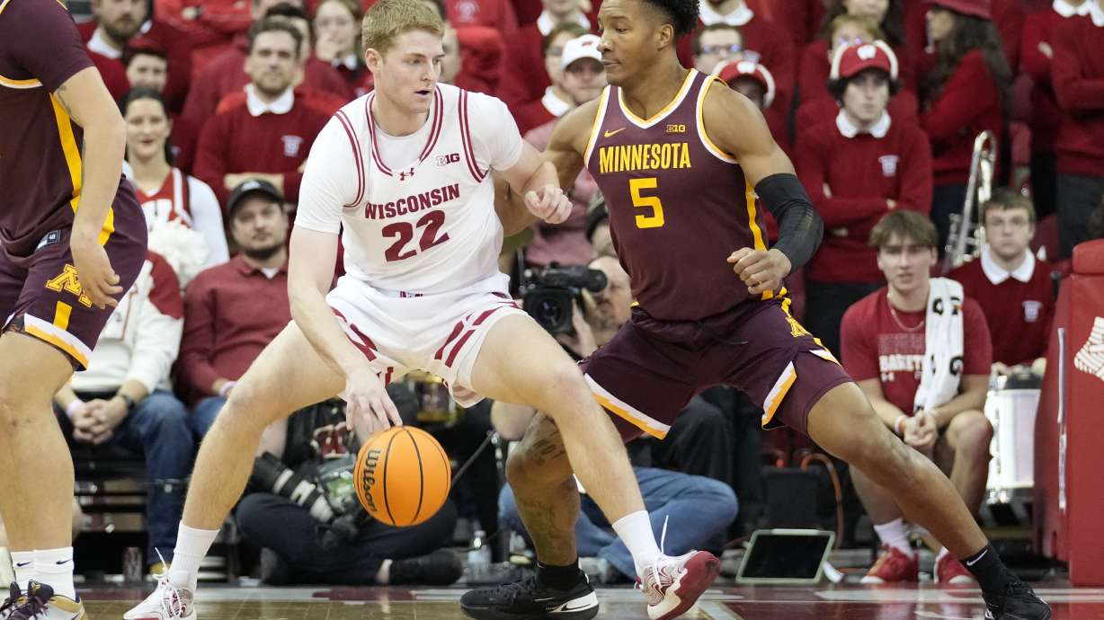Wisconsin forward Steven Crowl (22) dribbles against Minnesota center Trey Edmonds (5) during the first half of an NCAA college basketball game Friday, Jan. 10, 2025, in Madison, Wis.