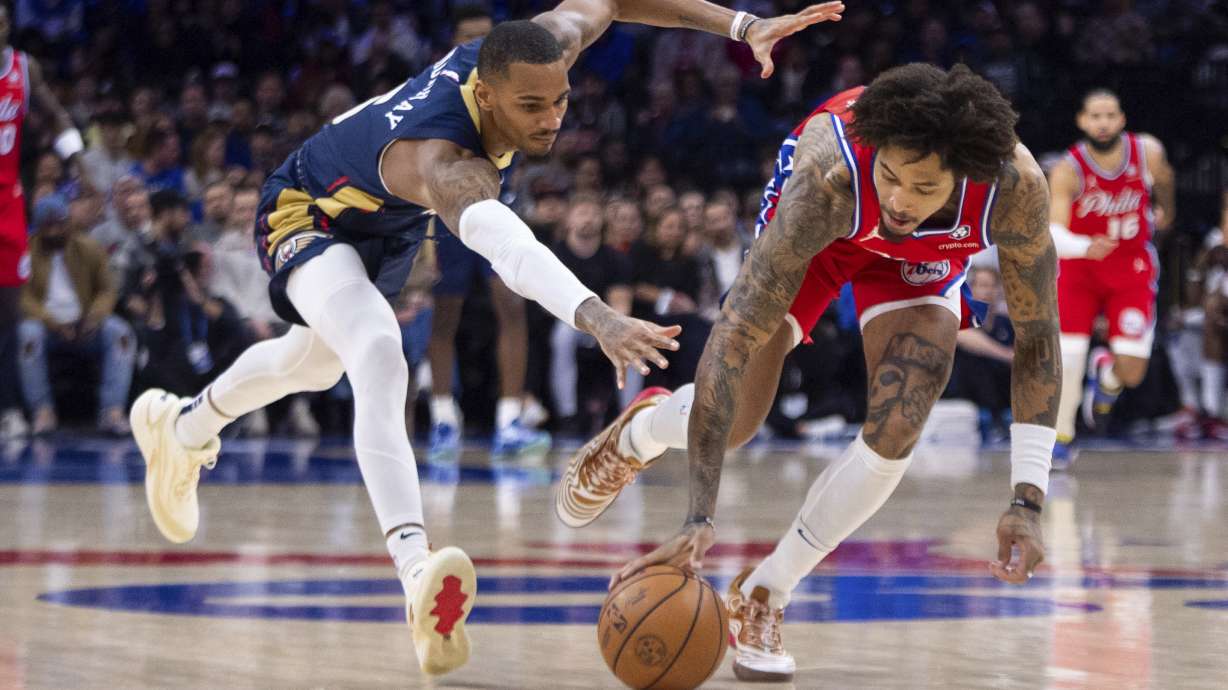 Philadelphia 76ers' Kelly Oubre Jr., right, goes after the ball against New Orleans Pelicans' Dejounte Murray, left, during the first half of an NBA basketball game, Friday, Jan. 10, 2025, in Philadelphia.