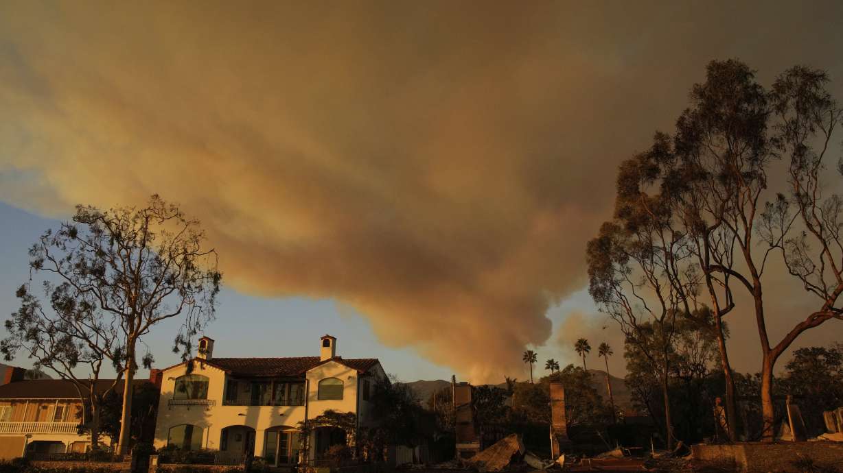 A plume of smoke rises from the Palisades Fire on Friday, in the Pacific Palisades section of Los Angeles.