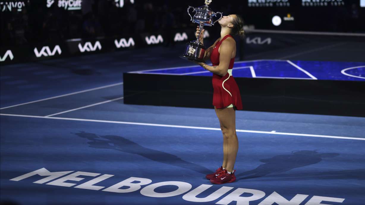 FILE - Aryna Sabalenka of Belarus kisses the Daphne Akhurst Memorial Cup after defeating Zheng Qinwen of China in the women's singles final at the Australian Open tennis championships at Melbourne Park, Melbourne, Australia, Saturday, Jan. 27, 2024.