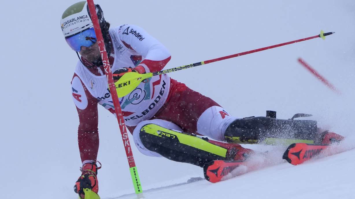 Austria's Manuel Feller speeds down the course during an alpine ski, men's World Cup slalom race, in Adelboden, Switzerland, Saturday, Jan. 11, 2025.
