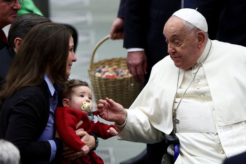 Pope Francis greets a child at the Jubilee audience in Paul VI hall at the Vatican, Saturday. President Joe Biden spoke awarded him the Presidential Medal of Freedom with Distinction.