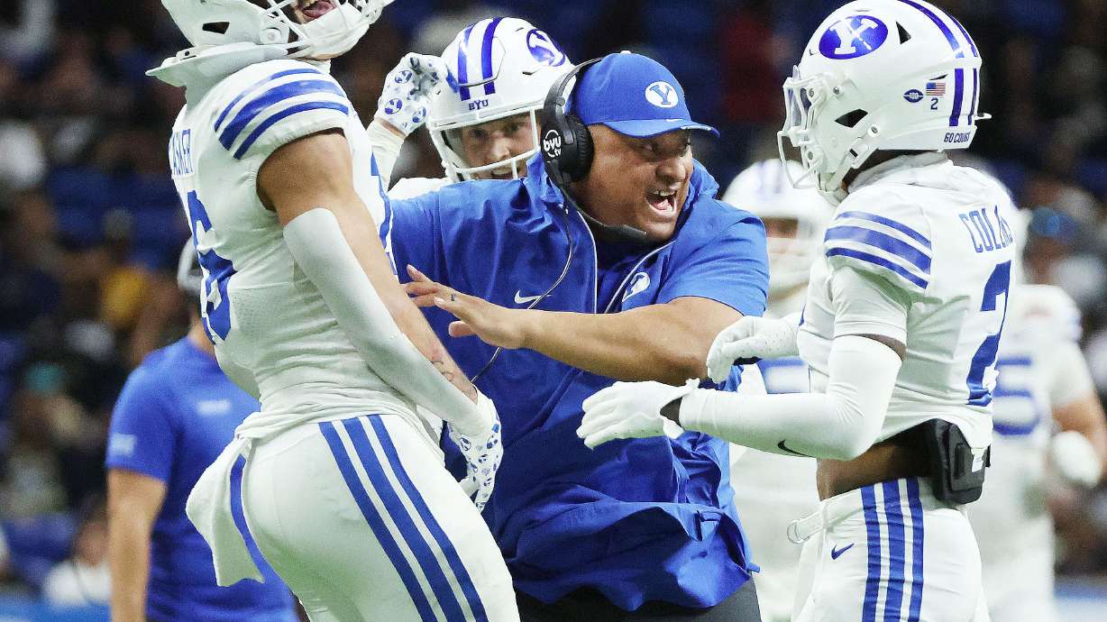 Brigham Young Cougars head coach Kalani Sitake celebrates an interception during the Valero Alamo Bowl in San Antonio on Saturday, Dec. 28, 2024. BYU won 36-14.