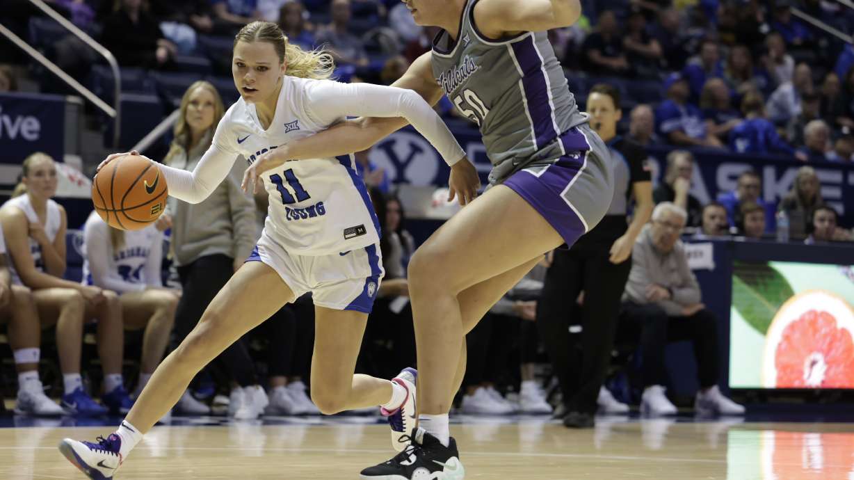 BYU guard Delaney Gibb drives to the rim by Kansas State's Ayoka Lee during a Big 12 women's basketball game, Saturday, Jan. 11, 2024 at the Marriott Center in Provo, Utah.