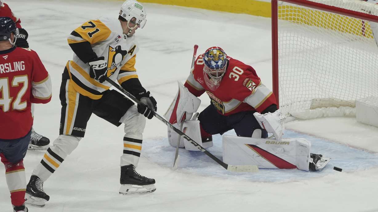 Florida Panthers goaltender Spencer Knight (30) stops a shot on goal by Pittsburgh Penguins center Evgeni Malkin (71) during the first period of an NHL hockey game, Friday, Jan. 3, 2025, in Sunrise, Fla.
