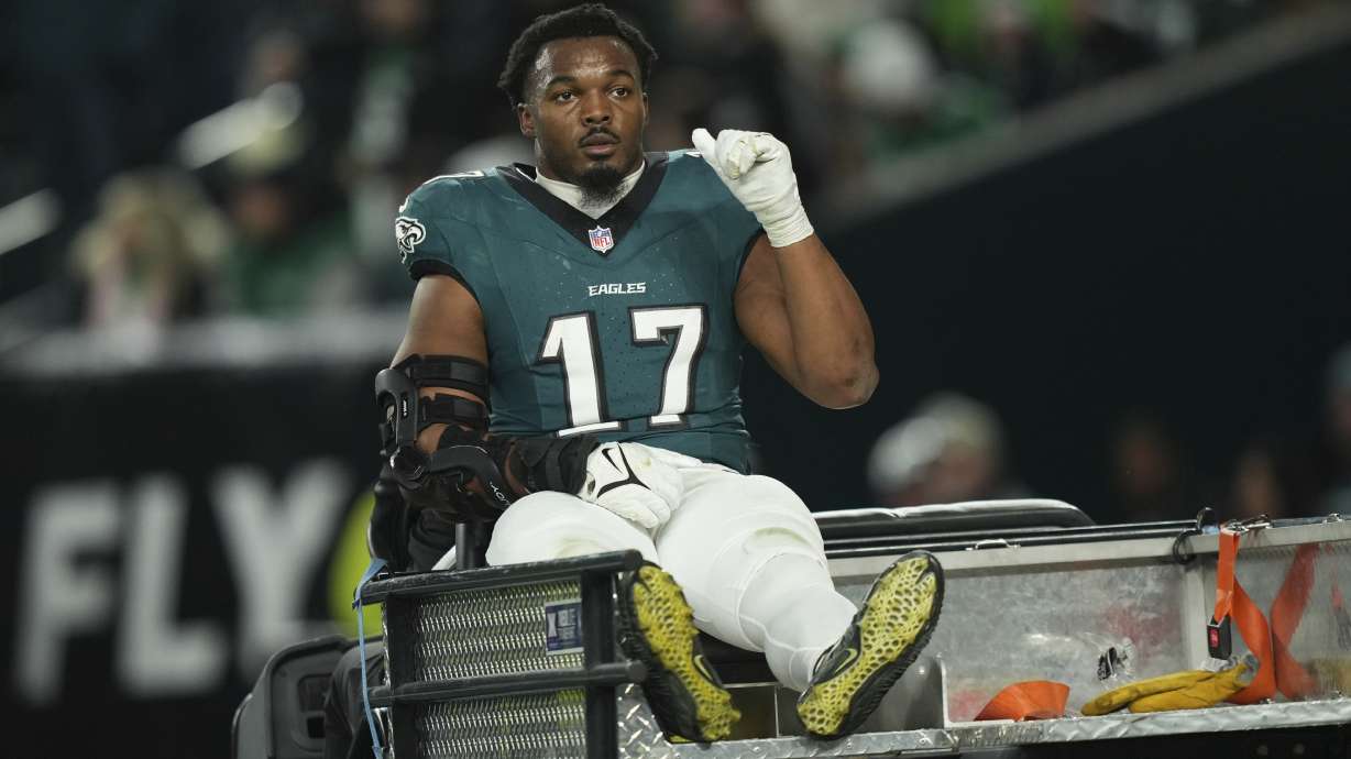 Philadelphia Eagles linebacker Nakobe Dean gestures as he is carted away after an injury during the first half of an NFL wild-card playoff football game against the Green Bay Packers on Sunday, Jan. 12, 2025, in Philadelphia.