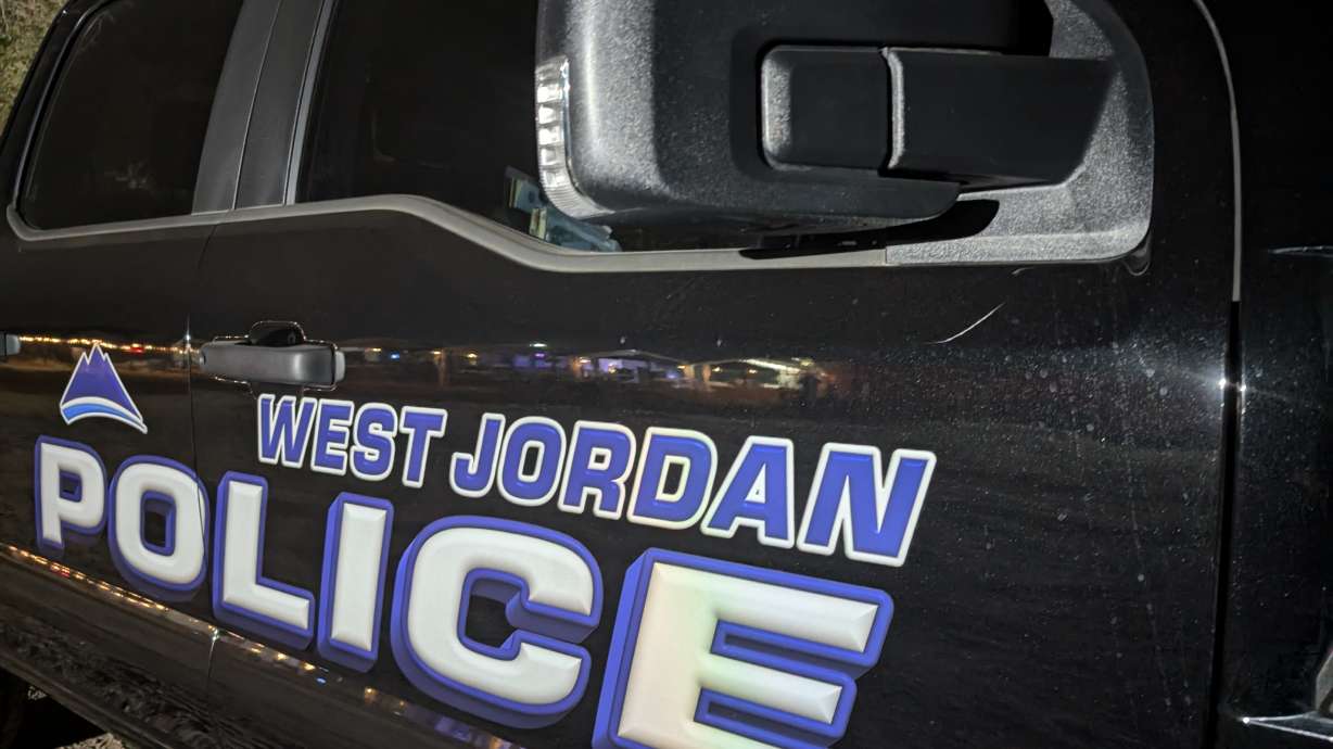 A man was arrested on New Year's Eve after police say he fired a round into a West Jordan hotel room floor, possibly on accident, and into an occupied room below.