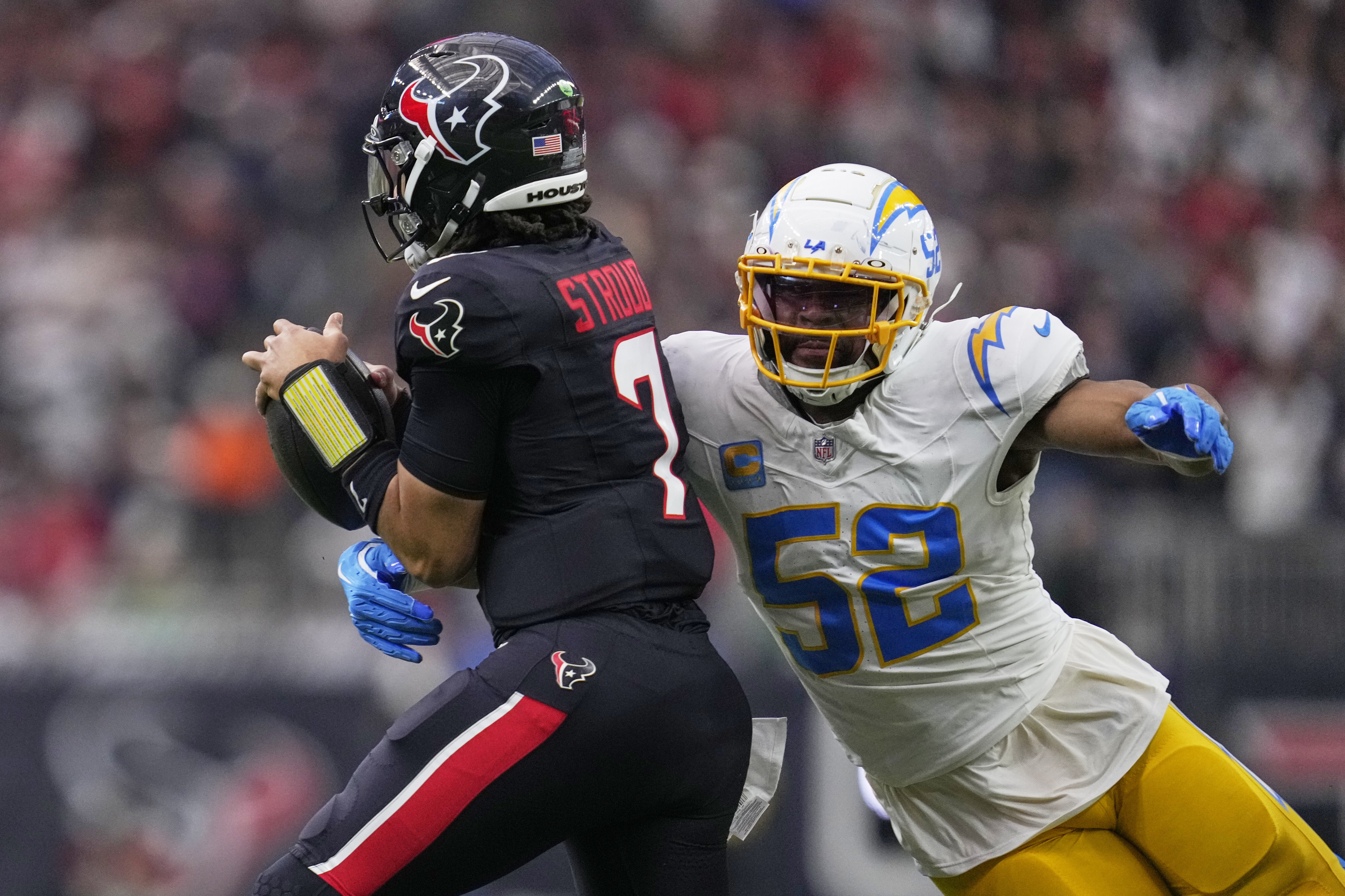 Houston Texans quarterback C.J. Stroud (7) is sacked by Los Angeles Chargers' Khalil Mack (52) during the first half of an NFL wild-card playoff football game Saturday, Jan. 11, 2025, in Houston.