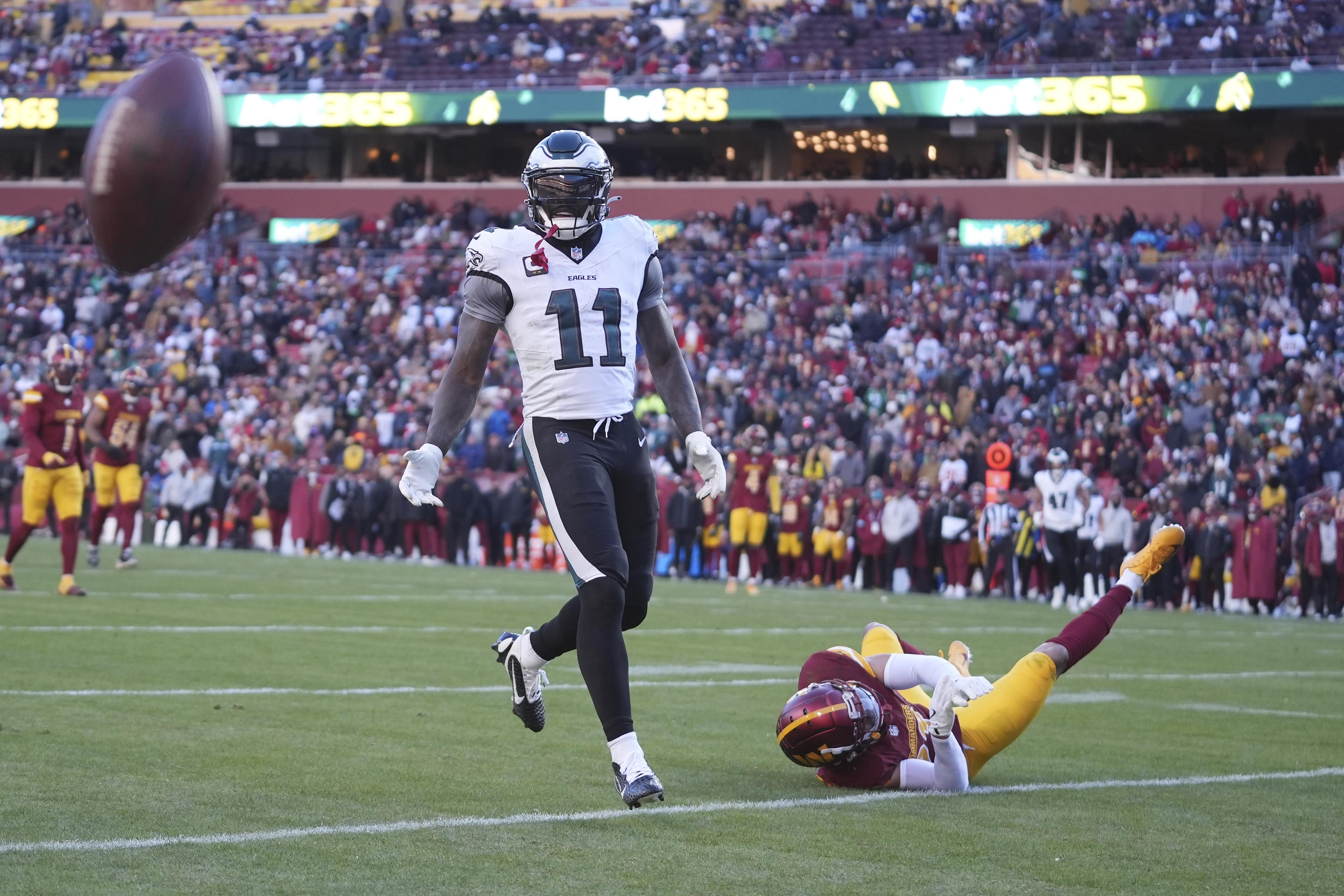 Washington Commanders cornerback Marshon Lattimore (23) is called for pass interference against Philadelphia Eagles wide receiver A.J. Brown (11) during the second half of an NFL football game, Sunday, Dec. 22, 2024, in Landover, Md.
