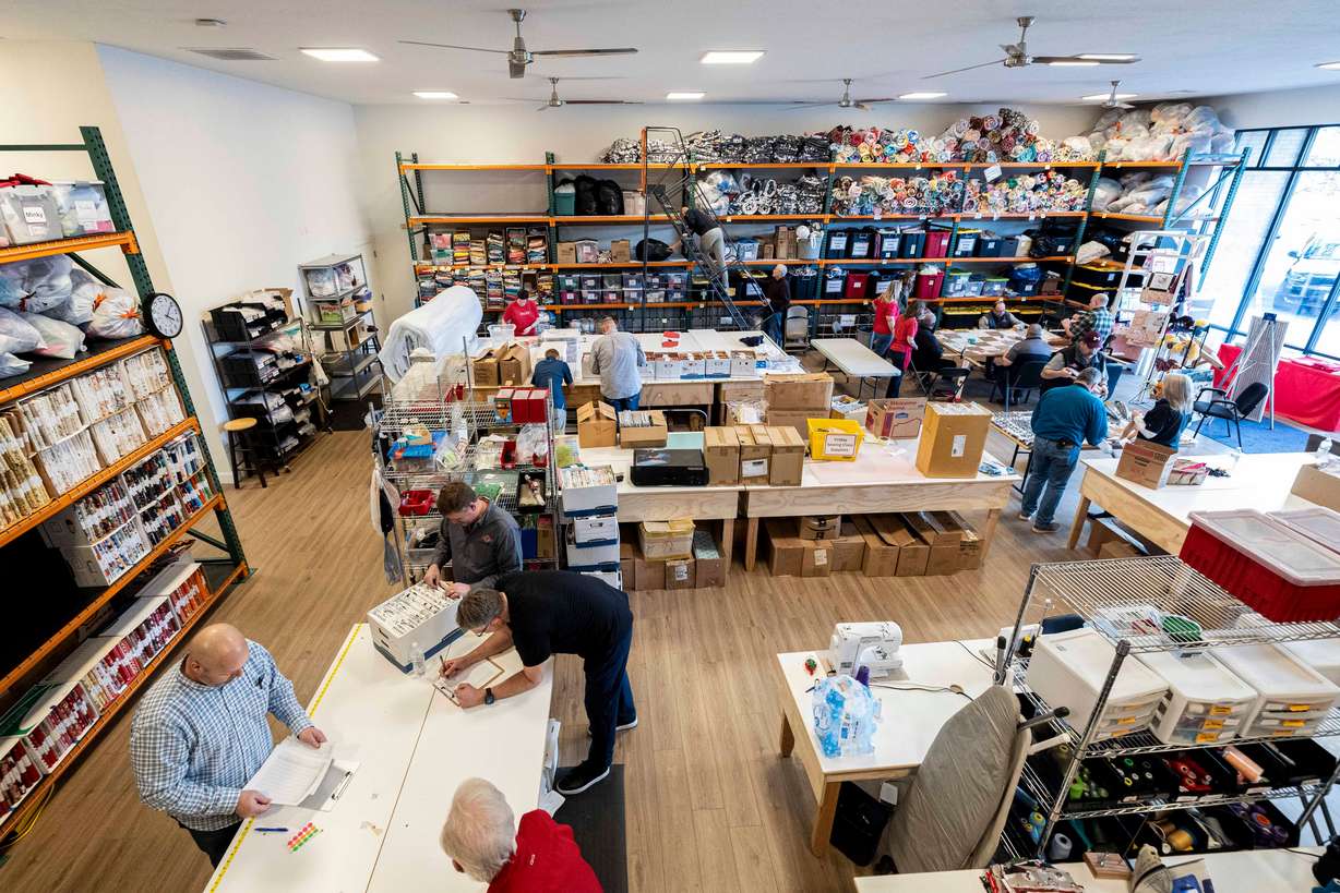 Volunteers from Asphalt Zipper work on various projects at Stitching Hearts Worldwide’s headquarters in Pleasant Grove on Jan. 7.