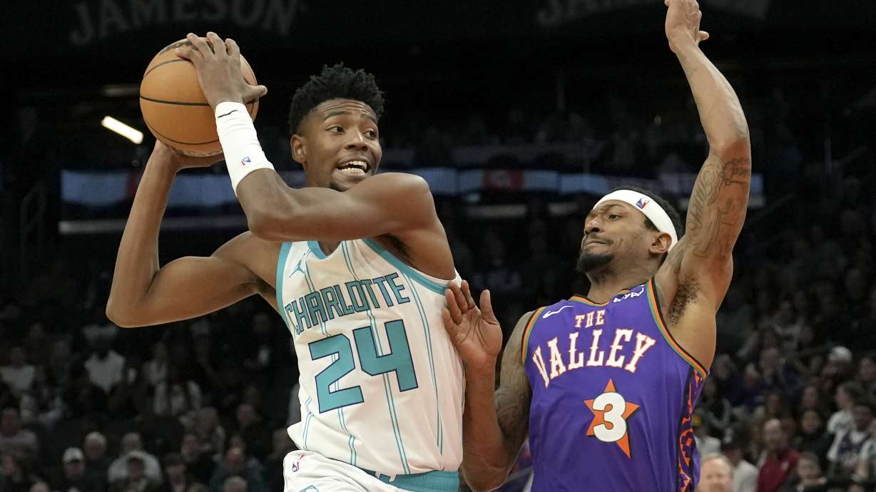 Charlotte Hornets forward Brandon Miller (24) drives to the basket against Phoenix Suns guard Bradley Beal (3) during the first half of an NBA basketball game Sunday, Jan. 12, 2025, in Phoenix.