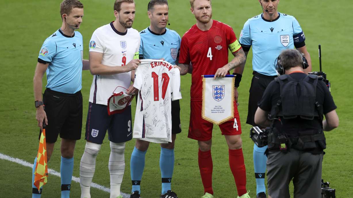 FILE - England's Harry Kane, 2nd left, hands to Denmark's Simon Kjaer an English shirt with the name of Denmark's Christian Eriksen before the Euro 2020 soccer championship semifinal match between England and Denmark at Wembley stadium in London, Wednesday, July 7, 2021.