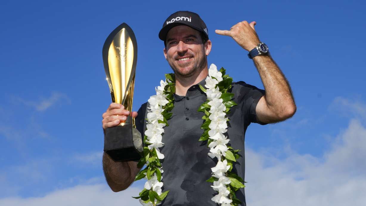 Nick Taylor, of Canada, poses with his trophy after winning the Sony Open golf event, Sunday, Jan. 12, 2025, at Waialae Country Club in Honolulu.