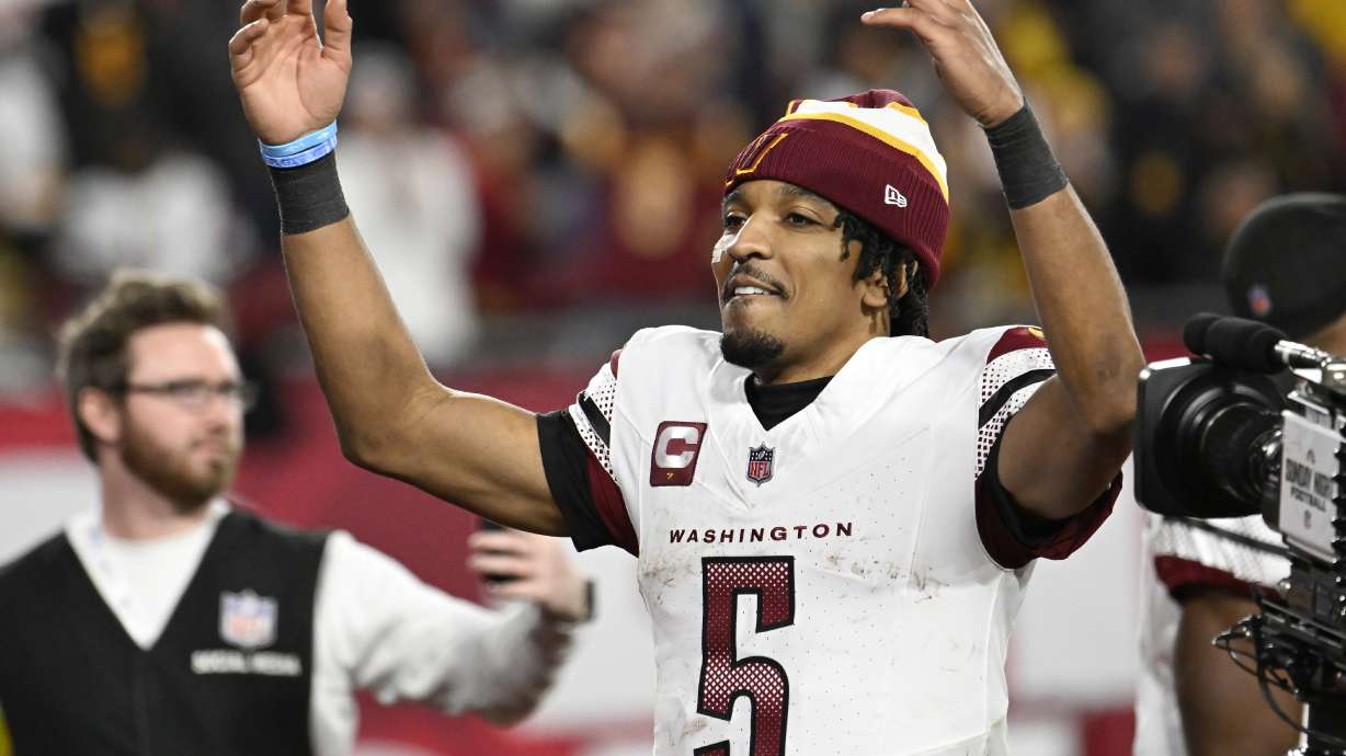Washington Commanders quarterback Jayden Daniels (5) celebrates after an NFL wild-card playoff football game against the Tampa Bay Buccaneers in Tampa, Fla., Sunday, Jan. 12, 2025.