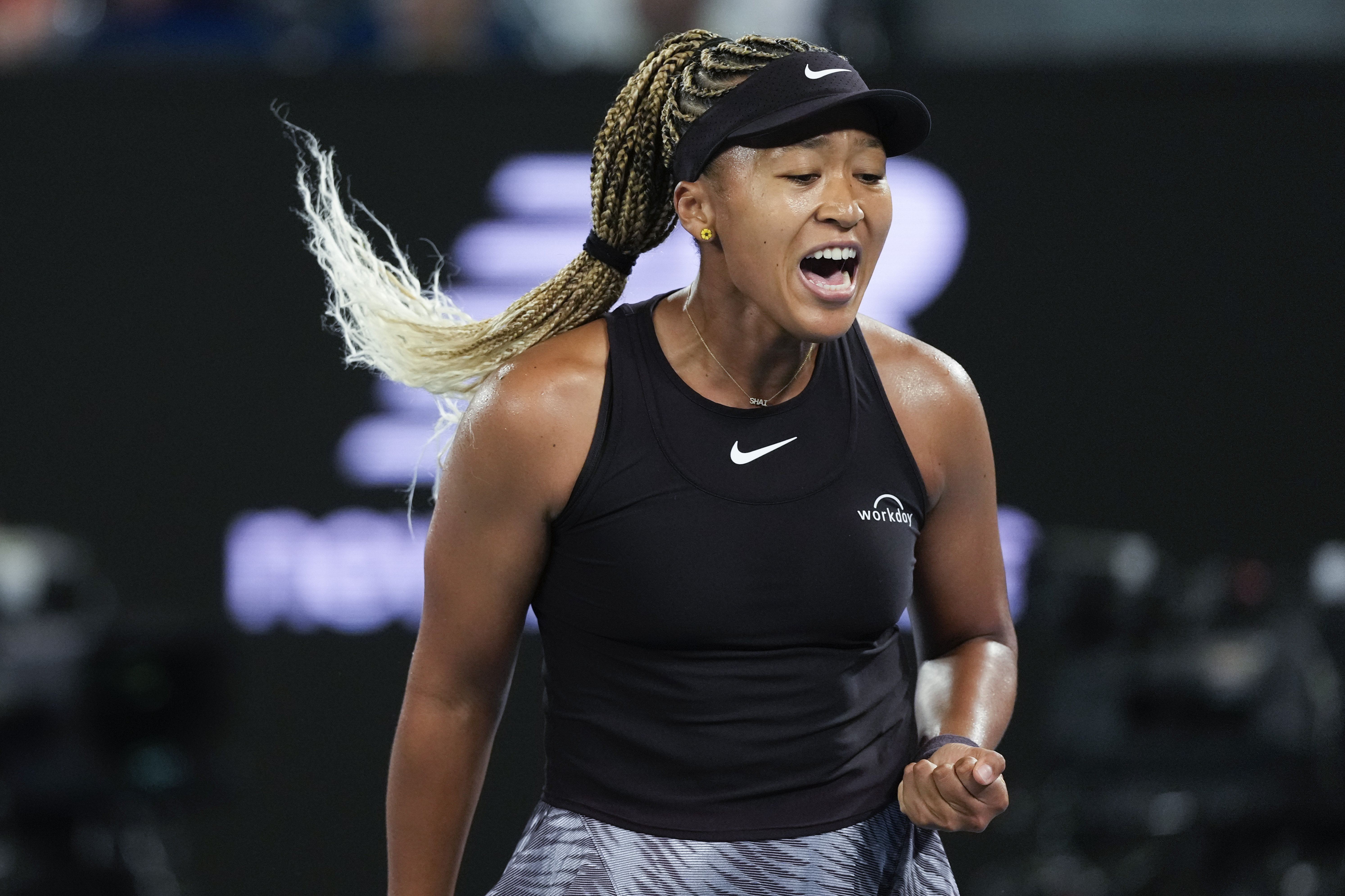 Naomi Osaka of Japan reacts during her first round match against Caroline Garcia of France at the Australian Open tennis championship in Melbourne, Australia, Monday, Jan. 13, 2025.