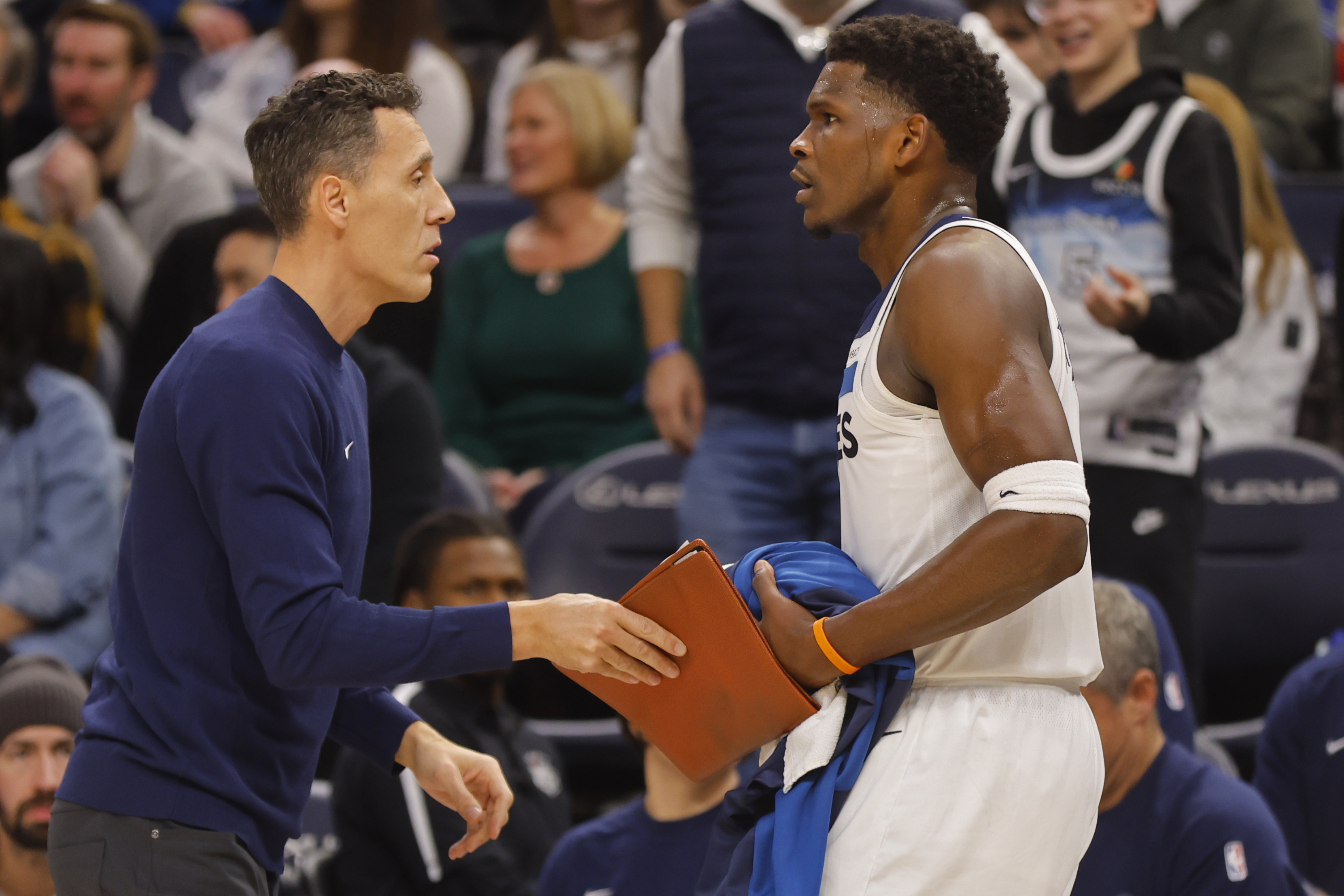 Minnesota Timberwolves assistant coach Pablo Prigioni, left, gets in the way of guard Anthony Edwards after Edwards received a technical foul in the third quarter of an NBA basketball game against the Memphis Grizzlies, Saturday, Jan. 11, 2025, in Minneapolis.