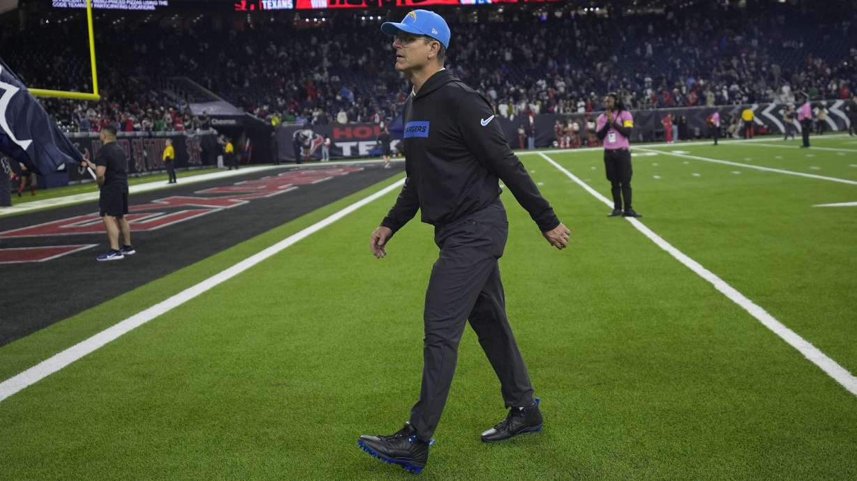 Los Angeles Chargers coach Jim Harbaugh leaves the field after an NFL wild-card playoff football game against the Houston Texans Saturday, Jan. 11, 2025, in Houston. The Texans won 32-12.