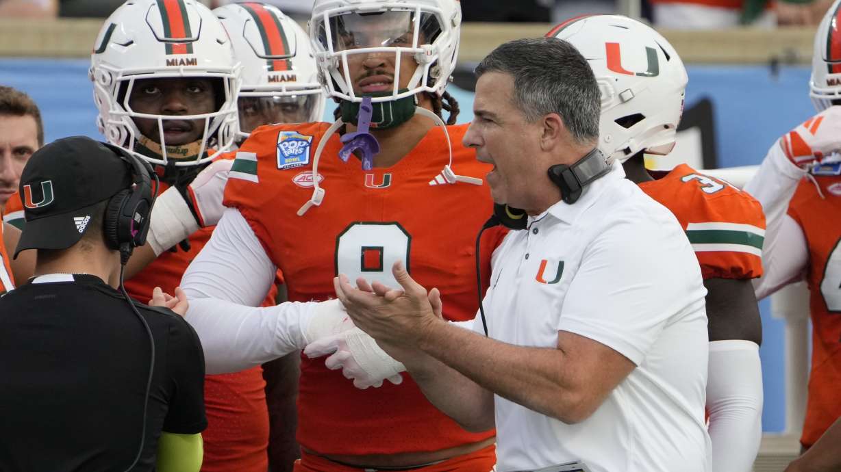 Miami head coach Mario Cristobal encourages his players as he paces the sideline during the first half of the Pop Tarts Bowl NCAA college football game against Iowa State, Saturday, Dec. 28, 2024, in Orlando, Fla.