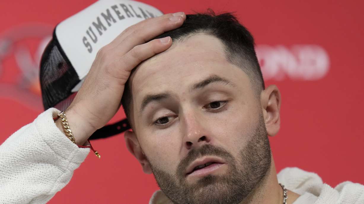 Tampa Bay Buccaneers quarterback Baker Mayfield reacts while speaking at a news conference after an NFL wild-card playoff football game against the Washington Commanders in Tampa, Fla., Sunday, Jan. 12, 2025.
