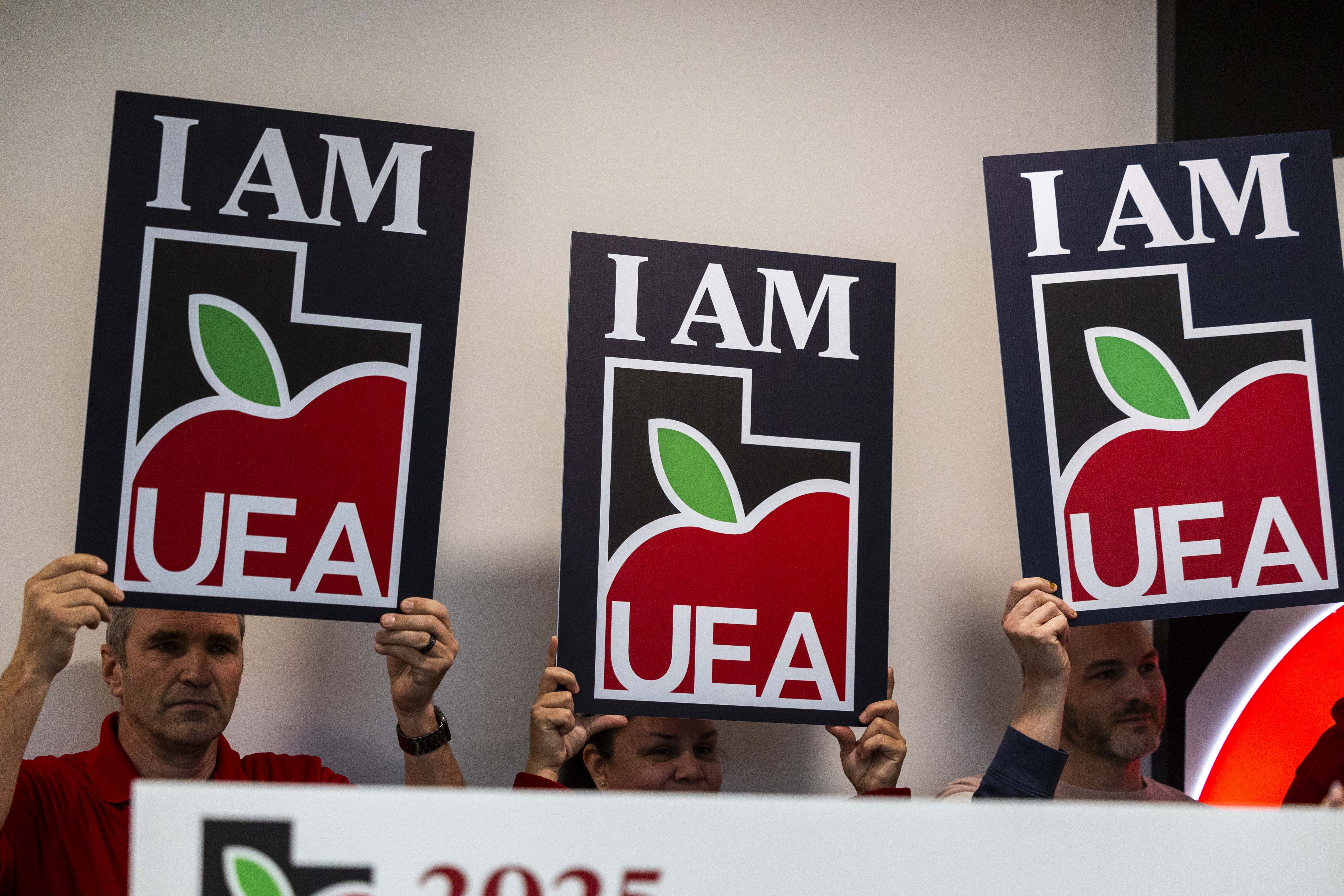 Teachers with the Utah Education Association hold signs during a press conference discussing the UEA’s 2025 legislative priorities and findings from its latest member survey, at the Utah Educators Association Headquarters in Murray on Monday.