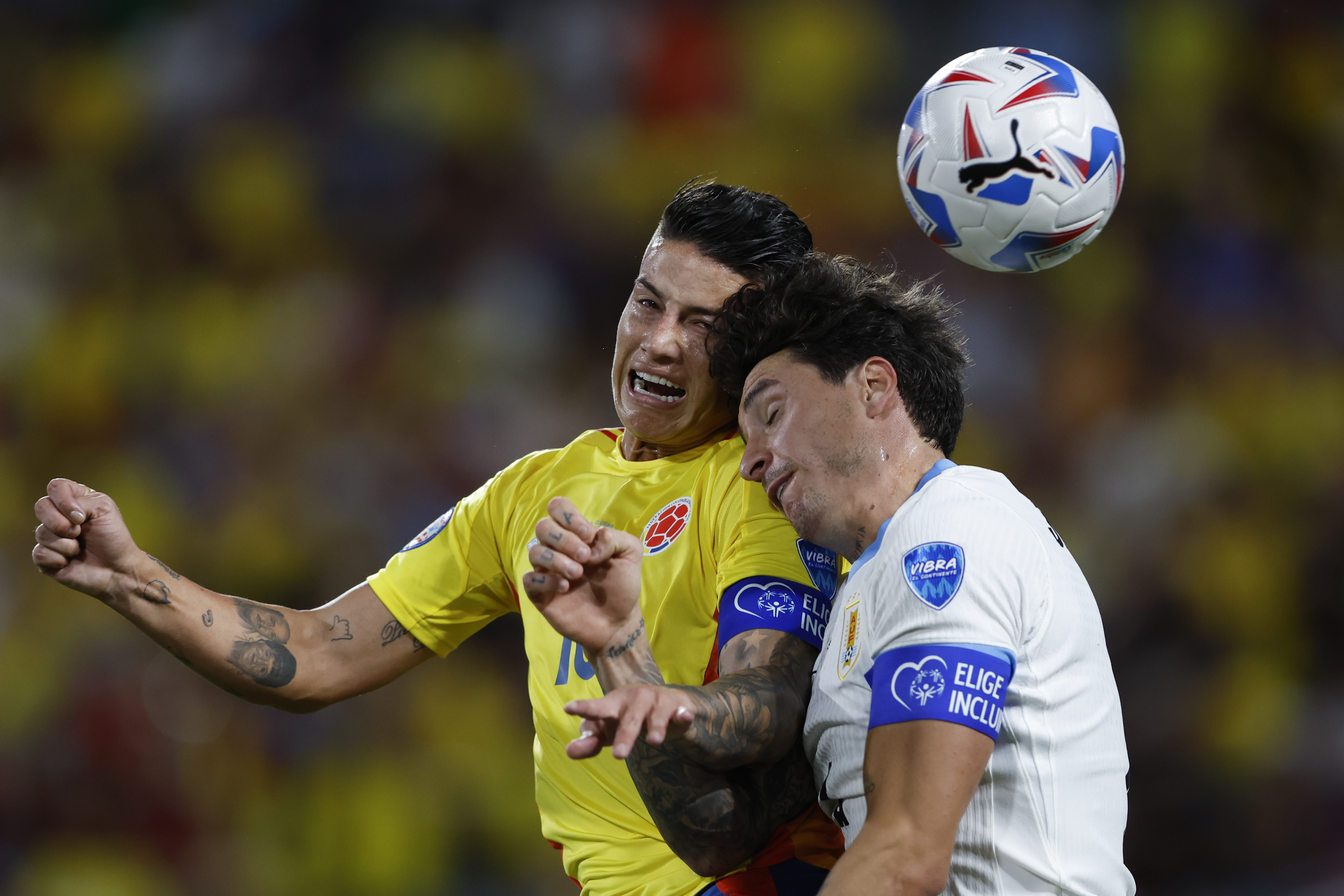 FILE - Colombia's James Rodriguez, left, and Uruguay's Jose Gimenez jump for a header during a Copa America semifinal soccer match in Charlotte, N.C., July 10, 2024.