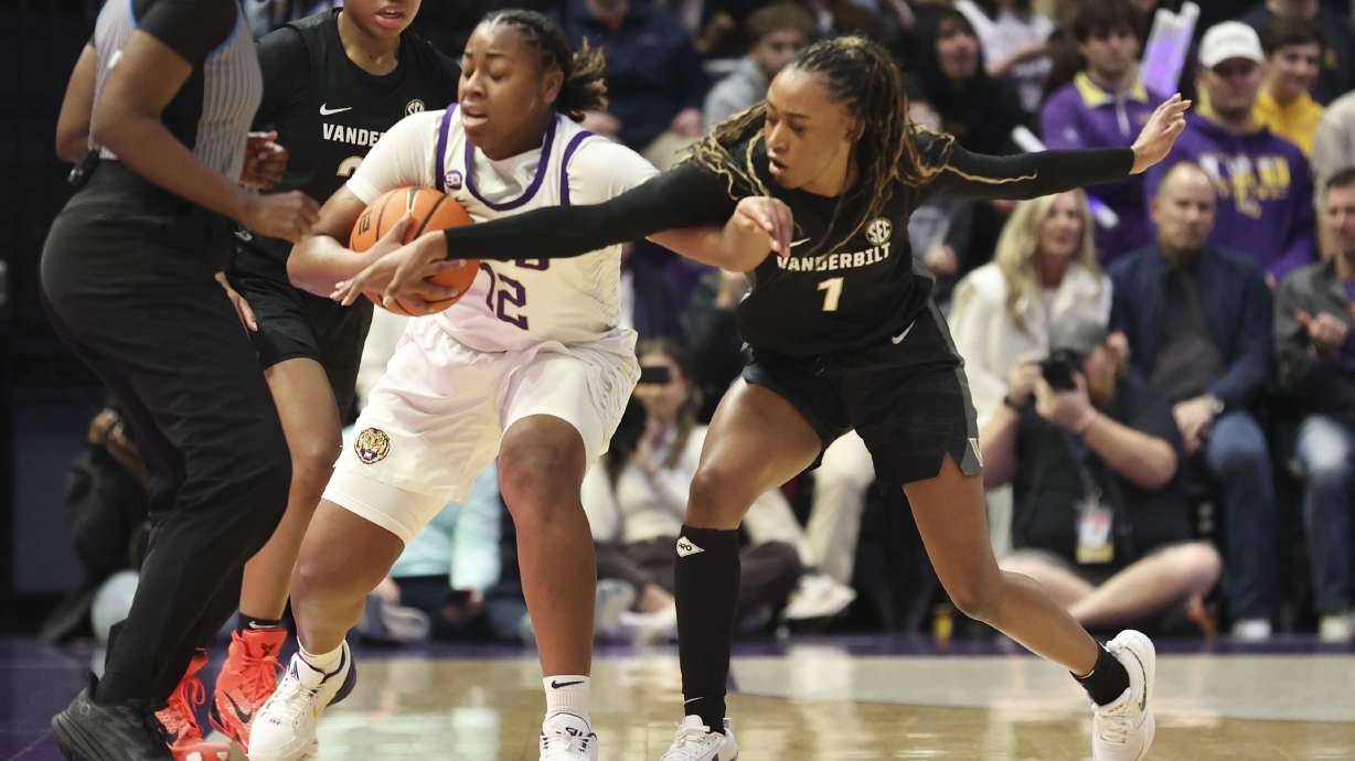 Vanderbilt guard Mikayla Blakes (1) tries to steal the ball from LSU guard Mikaylah Williams (12) during the first half of an NCAA college basketball game in Baton Rouge, La., Monday, Jan. 13, 2025.