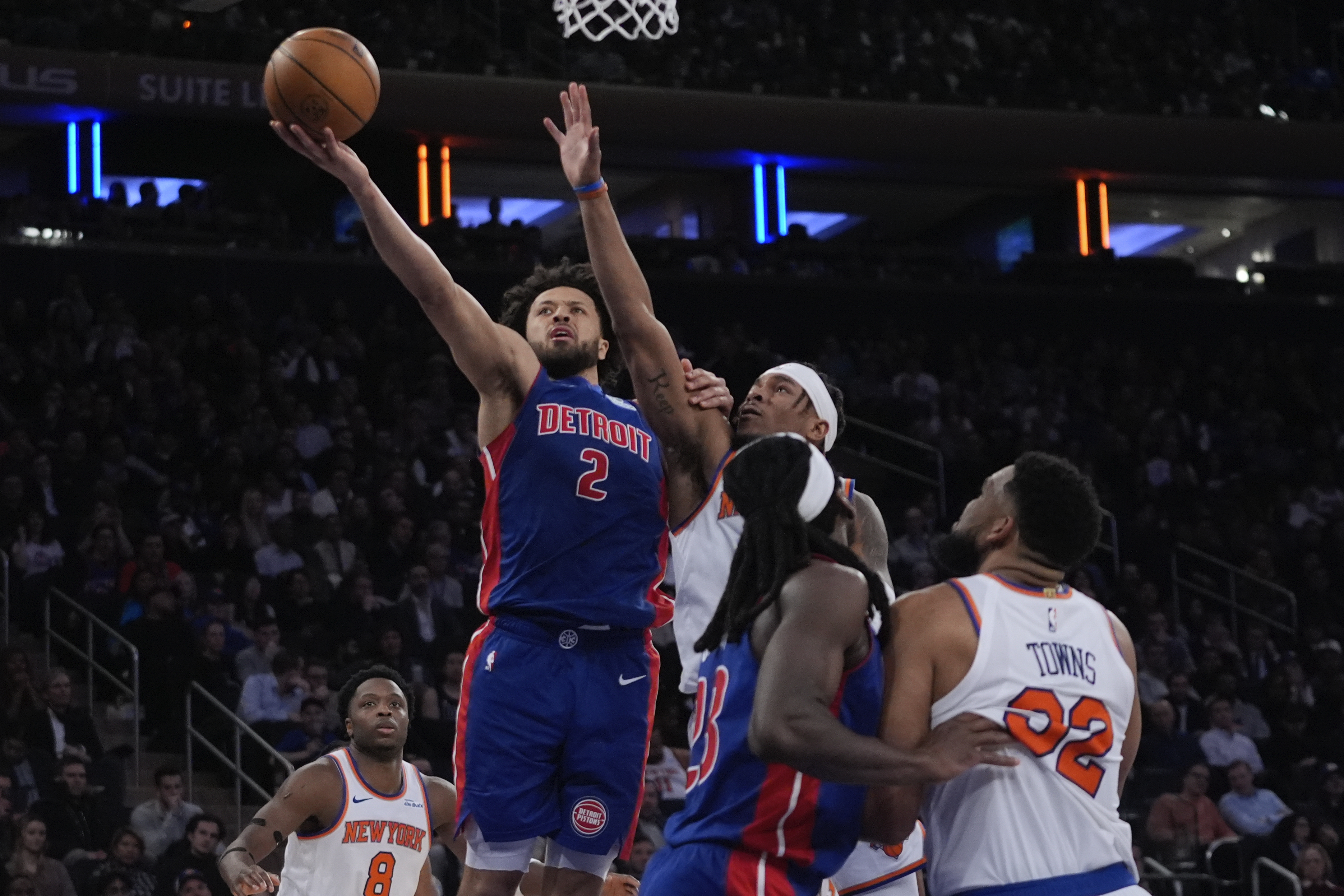 Detroit Pistons' Cade Cunningham (2) drives past New York Knicks' Miles McBride (2) during the second half of an NBA basketball game, Monday, Jan. 13, 2025, in New York.