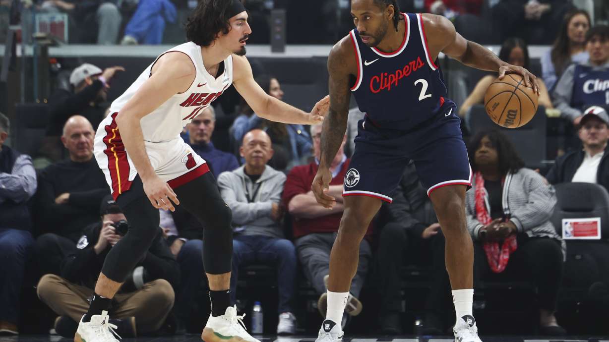Los Angeles Clippers forward Kawhi Leonard (2) dribbles against Miami Heat guard Jaime Jaquez Jr. (11) during the first half of an NBA basketball game, Monday, Jan. 13, 2025, in Los Angeles.